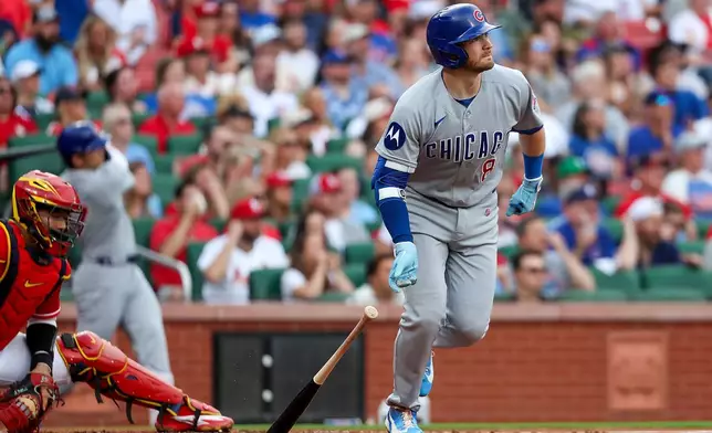 Chicago Cubs' Ian Happ, right, watches his three-run home run during the first inning against the St. Louis Cardinals, Friday, May 29, 2026, in St. Louis. (AP Photo/Scott Kane)