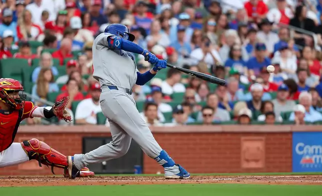 Chicago Cubs' Michael Busch an RBI single during the second inning of a baseball game against the St. Louis Cardinals Friday, May 29, 2026, in St. Louis. (AP Photo/Scott Kane)