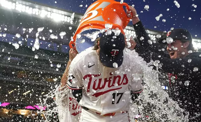 Minnesota Twins starting pitcher Bailey Ober (17) is doused with water by Brooks Lee, left, and Joe Ryan, right, after pitching a complete-game shutout of a baseball game against the Miami Marlins Tuesday, May 12, 2026, in Minneapolis. (AP Photo/Abbie Parr)
