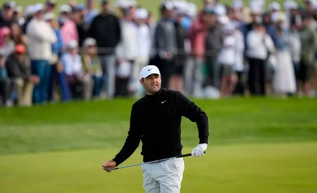 Scottie Scheffler watches his shot on the 10th green during the second round of the PGA Championship golf tournament at Aronimink Golf Club, Friday, May 15, 2026, in Newtown Square, PA. (AP Photo/Matt Slocum)
