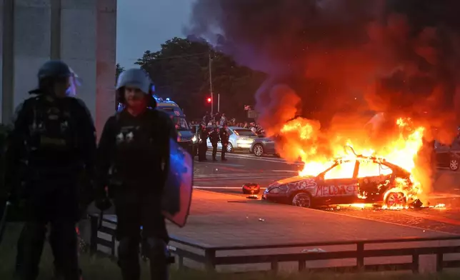 A car burns as PSG supporters celebrate in Paris, Saturday, May 30, 2026 after the Champions League final soccer match between Paris Saint-Germain and Arsenal that's being played in Budapest., PSG won the game. (AP Photo/Thomas Padilla)