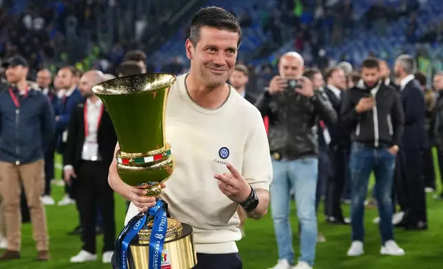Inter Milan head coach Cristian Chivu poses with the trophy after defeating Lazio to win the Italian Cup soccer final in Rome, Wednesday, May 13, 2026. (AP Photo/Andrew Medichini)