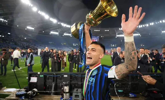 Inter Milan's team captain Lautaro Martinez shows the trophy to the supporters after defeating Lazio to win the Italian Cup soccer final in Rome, Wednesday, May 13, 2026. (AP Photo/Andrew Medichini)