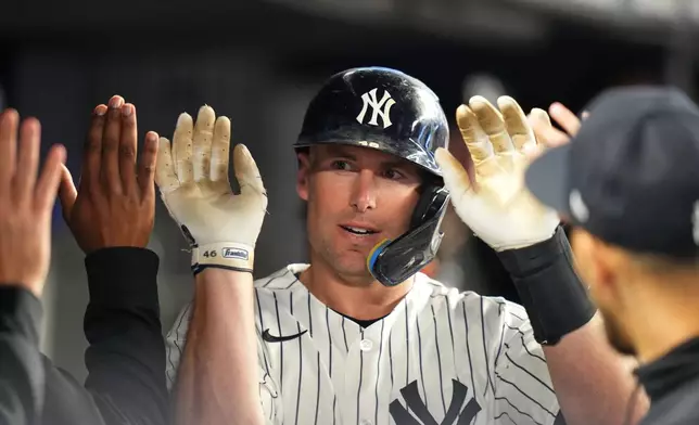 New York Yankees' Paul Goldschmidt celebrates with teammates after hitting a home run during the eighth inning of a baseball game against the Texas Rangers Tuesday, May 5, 2026, in New York. (AP Photo/Frank Franklin II)