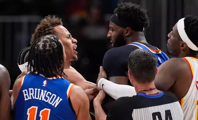 New York Knicks center Mitchell Robinson (23) and Atlanta Hawks guard Dyson Daniels (5) fight in the first half during Game 6 in a first-round NBA basketball playoffs series Thursday, April 30, 2026, in Atlanta. (AP Photo/Brynn Anderson)