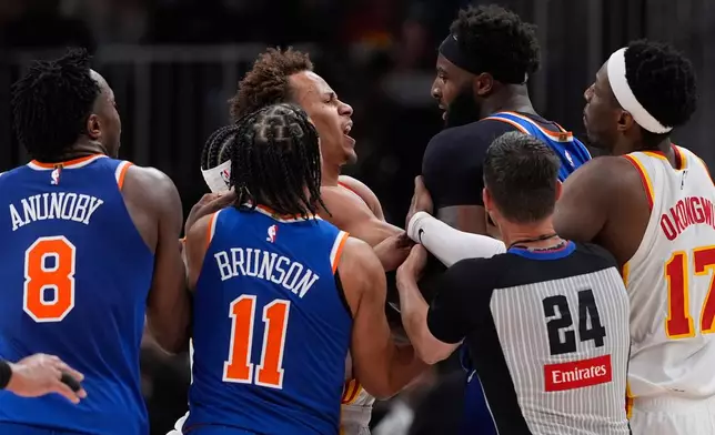 New York Knicks center Mitchell Robinson (23) and Atlanta Hawks guard Dyson Daniels (5) fight in the first half during Game 6 in a first-round NBA basketball playoffs series Thursday, April 30, 2026, in Atlanta. (AP Photo/Brynn Anderson)