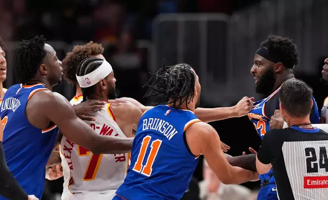 New York Knicks center Mitchell Robinson (23) and Atlanta Hawks guard Dyson Daniels (5) fight in the first half during Game 6 in a first-round NBA basketball playoffs series Thursday, April 30, 2026, in Atlanta. (AP Photo/Brynn Anderson)
