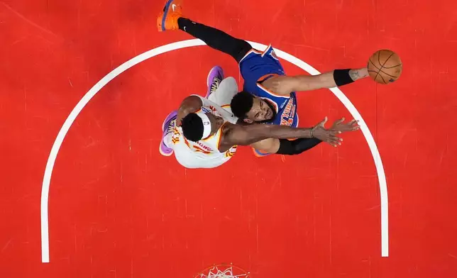 New York Knicks center Karl-Anthony Towns (32) shoots during Game 6 in a first-round NBA basketball playoffs series against the Atlanta Hawks Thursday, April 30, 2026, in Atlanta. (AP Photo/Brynn Anderson)