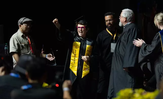 Tennis legend Billie Jean King raises her fist after being called to receive her diploma during California State University, Los Angeles, commencement in Los Angeles, Monday, May 18, 2026. (AP Photo/Jae C. Hong)