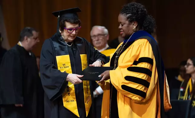 Tennis legend Billie Jean King, left, receives her diploma from California State University, Los Angeles, President Berenecea Johnson Eanes during commencement in Los Angeles, Monday, May 18, 2026. (AP Photo/Jae C. Hong)