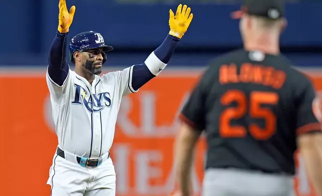 Tampa Bay Rays' Yandy Díaz, left, celebrates after his RBI double off Baltimore Orioles pitcher Kyle Bradish during the first inning of a baseball game Tuesday, May 19, 2026, in St. Petersburg, Fla. (AP Photo/Chris O'Meara)