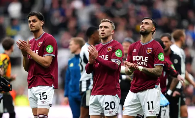 From left, West Ham United's Konstantinos Mavropanos, Jarrod Bowen and Valentin Castellanos applauds the fans following their English Premier League soccer match against Newcastle United in Newcastle upon Tyne, England, Sunday, May 17, 2026. (Owen Humphreys/PA via AP)