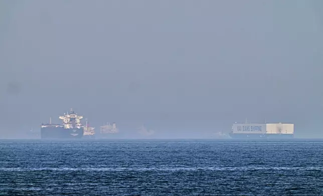 A tanker, left, and a car carrier are anchored at sea in the Gulf of Oman near the Strait of Hormuz, as seen from the coast near Khor Fakkan, United Arab Emirates, Friday, May 1, 2026.(AP Photo/Fatima Shbair)