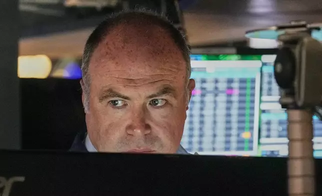 Trader Derek Orth works on the floor of the New York Stock Exchange, Thursday, April 30, 2026. (AP Photo/Richard Drew)