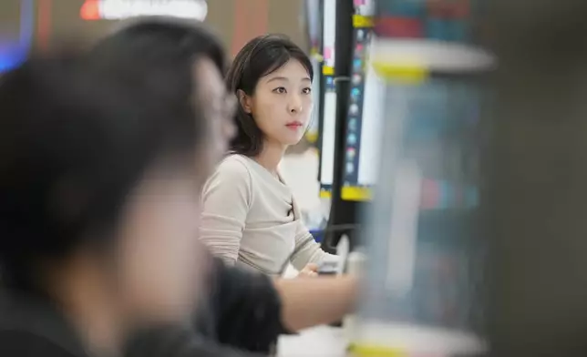 A dealer watches computer monitors at a dealing room of Hana Bank in Seoul, South Korea, Monday, May 4, 2026. (AP Photo/Lee Jin-man)