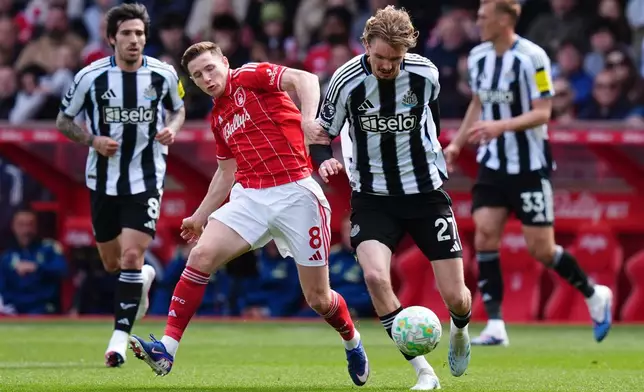 Newcastle United's Nick Woltemade, right, and Nottingham Forest's Elliot Anderson battle for the ball during the English Premier League soccer match between Nottingham Forest and Newcastle United in Nottingham, England, Sunday May 10, 2026. (Jacob King/PA via AP)