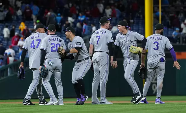 The Colorado Rockies celebrate their win after a baseball game against the Philadelphia Phillies, Friday, May 8, 2026, in Philadelphia. (AP Photo/Matt Rourke)