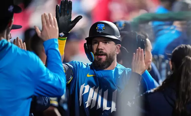 Philadelphia Phillies' Kyle Schwarber celebrates his home run off of Colorado Rockies pitcher Chase Dollander during the sixth inning of a baseball game, Friday, May 8, 2026, in Philadelphia. (AP Photo/Matt Rourke)
