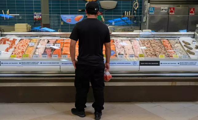 A person looks at the fresh fish at a grocery store Monday, May 11, 2026, in Nashville, Tenn. (AP Photo/George Walker IV)