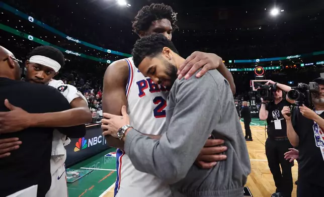 Boston Celtics' Jayson Tatum (right) and Philadelphia 76ers' Joel Embiid (left) embrace following Philadelphia's victory in Game 7 in a first-round NBA basketball playoffs series, Saturday, May 2, 2026 in Boston. (AP Photo/Jim Davis)