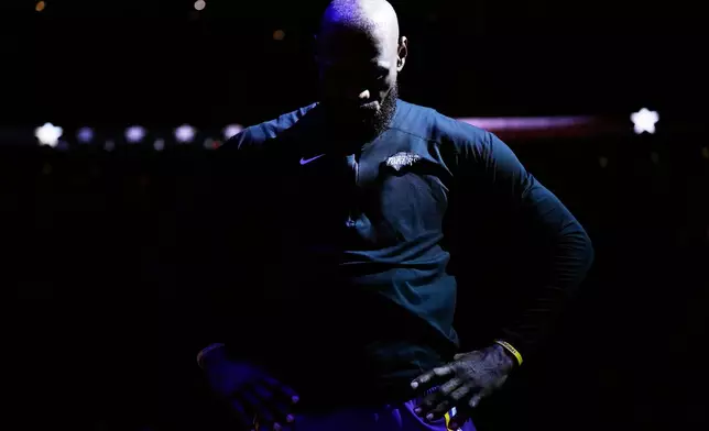 Los Angeles Lakers forward LeBron James (23) stands as the national anthem plays before Game 6 of a first-round NBA playoffs basketball series against the Houston Rockets in Houston, Friday, May 1, 2026. (AP Photo/Ashley Landis)