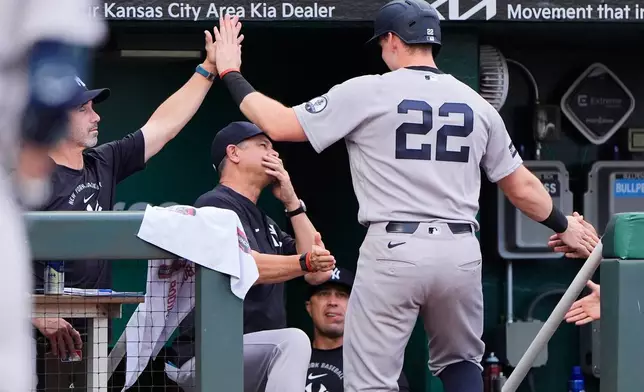 New York Yankees' Ben Rice (22) celebrates in the dugout after scoring on a single by Anthony Volpe during the third inning of baseball game against the Kansas City Royals, Tuesday, May 26, 2026, in Kansas City, Mo. (AP Photo/Charlie Riedel)