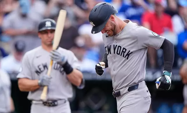 New York Yankees' Cody Bellinger runs home after hitting a solo home run during the first inning of baseball game against the Kansas City Royals, Tuesday, May 26, 2026, in Kansas City, Mo. (AP Photo/Charlie Riedel)
