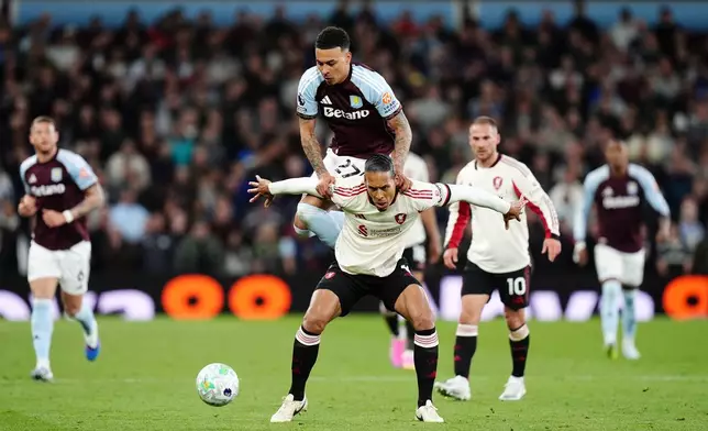 Liverpool's Virgil van Dijk, front, tries to block Aston Villa's Morgan Rogers from the ball during the English Premier League soccer match between Aston Villa and Liverpool in Birmingham, England, Friday, May 15, 2026. (Jacob King/PA via AP)