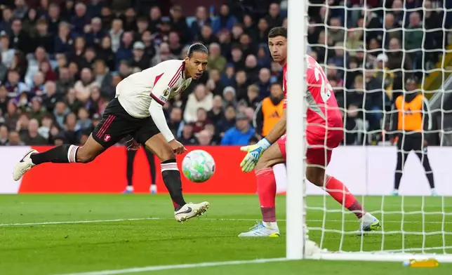 Liverpool's Virgil van Dijk, left, scores a goal during the English Premier League soccer match between Aston Villa and Liverpool in Birmingham, England, Friday, May 15, 2026. (David Davies/PA via AP)