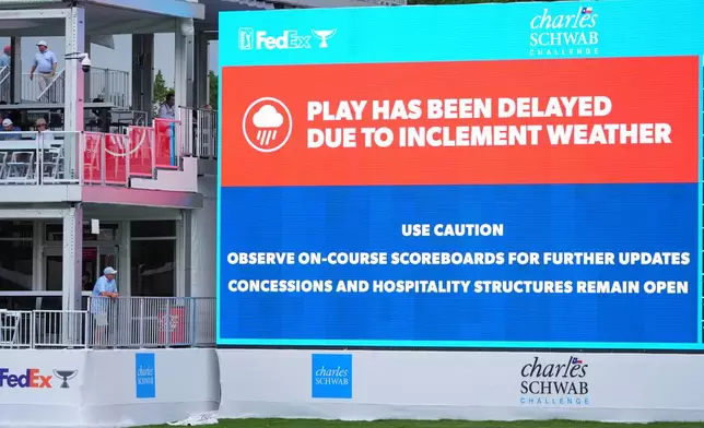 A sign announces that play has been delayed due to inclement weather during the first round of the Charles Schwab Challenge golf tournament at Colonial Country Club in Fort Worth, Texas, Thursday, May 28, 2026. (AP Photo/LM Otero)