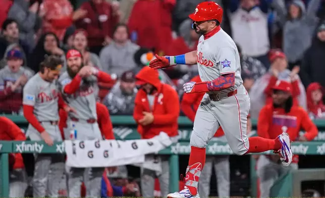 Philadelphia Phillies' Kyle Schwarber celebrates while rounding the bases on his two-run home run during the eighth inning of a baseball game against the Boston Red Sox, Thursday, May 14, 2026, in Boston. (AP Photo/Charles Krupa)