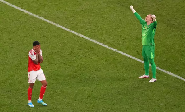 PSG's goalkeeper Matvey Safonov, right, celebrates while Arsenal's Gabriel Magalhaes reacts after failing to score during a penalty shootout after extra time during the Champions League final soccer match between Paris Saint-Germain and Arsenal in Budapest, Hungary, Saturday, May 30, 2026. (AP Photo/Vadim Ghirda)
