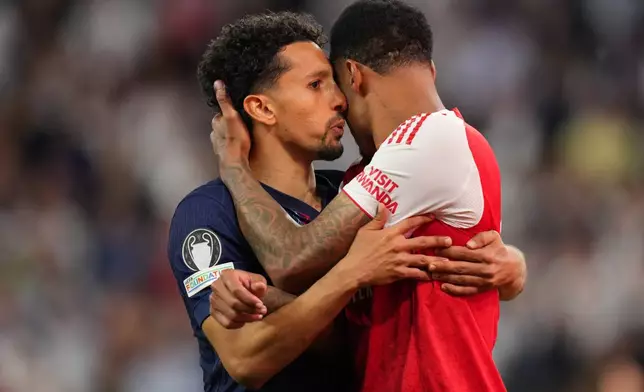 PSG's Marquinhos embraces Arsenal's Gabriel Magalhaes after the penalty shoot out at the Champions League final soccer match between Paris Saint-Germain and Arsenal in Budapest, Hungary, Saturday, May 30, 2026. (AP Photo/Andreea Alexandru)