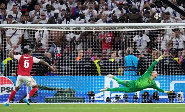 Arsenal's Gabriel Magalhaes shoots over the bar during a penalty shootout after extra time during the Champions League final soccer match between Paris Saint-Germain and Arsenal in Budapest, Hungary, Saturday, May 30, 2026. (AP Photo/Petr Josek)