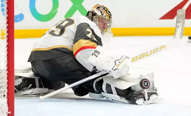Vegas Golden Knights goaltender Carter Hart deflects a shot during the third period in Game 6 of a second-round NHL hockey Stanley Cup playoff series against the Anaheim Ducks, Thursday, May 14, 2026, in Anaheim, Calif. (AP Photo/Mark J. Terrill)