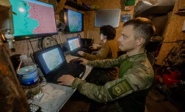 Ukrainian servicemen of Khartia brigade check the drone aerial view in the command centre Kharkiv region, Ukraine, Wednesday, May 20, 2026. (AP Photo/Andrii Marienko)