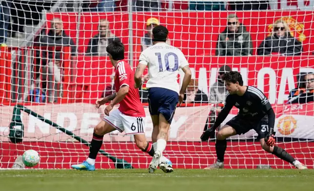 Nottingham Forest's Morgan Gibbs-White, centre, scores his side's second goal during the English Premier League soccer match between Manchester United and Nottingham Forest in Manchester, England, Sunday, May 17, 2026. (AP Photo/Dave Thompson)