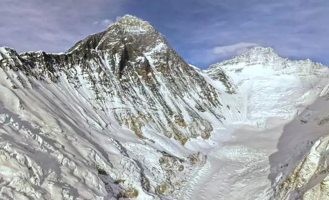 Mount Everest is seen, center left, from base camp in Nepal, Sunday, May 10, 2026. (AP Photo/Pasang Rinzee Sherpa)