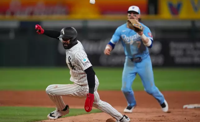Chicago White Sox's Derek Hill, left, is caught in between bases and tagged out by Kansas City Royals shortstop Bobby Witt Jr. (7) during the eighth inning of a baseball game, Thursday, May 14, 2026, in Chicago. (AP Photo/Erin Hooley)