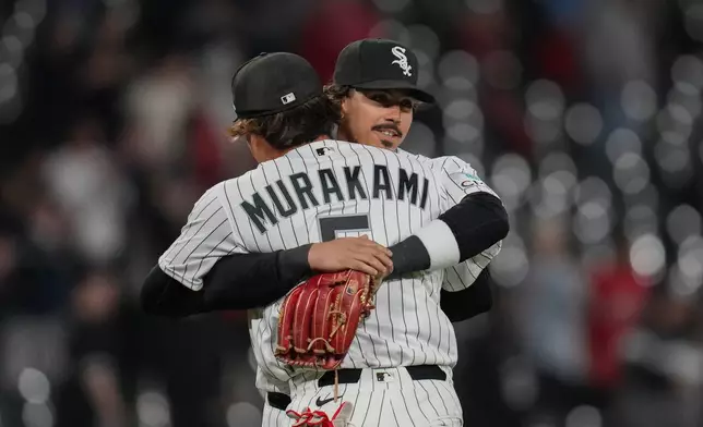 Chicago White Sox third baseman Miguel Vargas, right, hugs first baseman Munetaka Murakami as they celebrate their team's win over the Kansas City Royals in a baseball game Thursday, May 14, 2026, in Chicago. (AP Photo/Erin Hooley)
