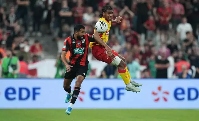 Lens' Kyllian Antonio, right, challenges for the ball with Nice's Ali Abdi, left, during the French Cup soccer final between Nice and Lens in Saint-Denis, outside Paris, Friday, May 22, 2026. (AP Photo/Thibault Camus)