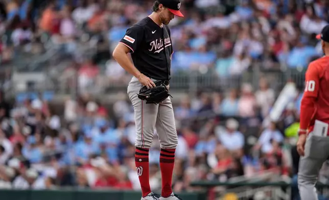 Washington Nationals pitcher Jake Irvin stands on the mound before walking off the field in the sixth inning of a baseball game against the Atlanta Braves, Saturday, May 23, 2026, in Atlanta. (AP Photo/Mike Stewart)