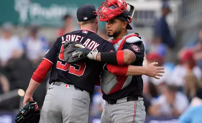 Washington Nationals pitcher Richard Lovelady embraces Washington Nationals catcher Keibert Ruiz for a win over the Atlanta Braves after a baseball game, Saturday, May 23, 2026, in Atlanta. (AP Photo/Mike Stewart,