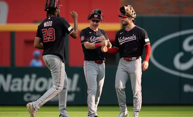 Washington Nationals players celebrate a win over the Atlanta Braves after a baseball game, Saturday, May 23, 2026, in Atlanta. (AP Photo/Mike Stewart)