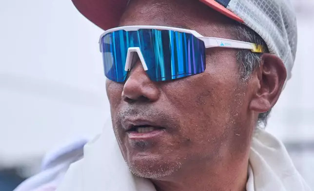 Renowned Sherpa mountain guide Kami Rita returning from Mount Everest after his record 32nd successful ascent, arrives at an airport in Kathmandu, Nepal, Friday, May 22, 2026. (AP Photo/Niranjan Shrestha)