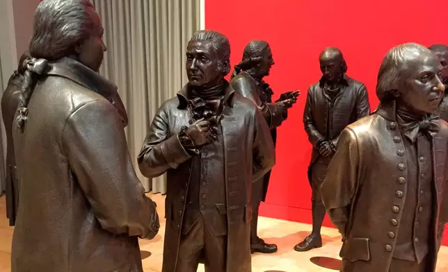 FILE - Life-size bronze sculptures of the signers of the U.S. Constitution stand in the Signers' Hall on July 7, 2016, at the National Constitution Center in Philadelphia. (AP Photo/Beth J. Harpaz, File)