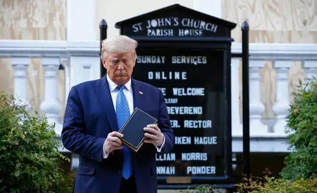 FILE - President Donald Trump holds a Bible as he stands outside St. John's Church, across Lafayette Park from the White House, on June 1, 2020, in Washington. (AP Photo/Patrick Semansky, File)
