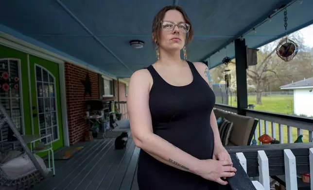 Stormy Bost stands on her porch in Calhoun, Ga., on March 29, 2026. (Miguel Martinez/Atlanta Journal-Constitution via AP)
