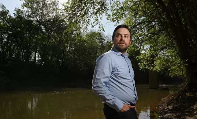 Jesse Demonbreun-Chapman, executive director and riverkeeper for the Coosa River Basin Initiative, poses for a portrait on the banks of the Coosawattee River at the New Echota launch in Calhoun, Ga., on April 3, 2026. (Hyosub Shin/Atlanta Journal-Constitution via AP)