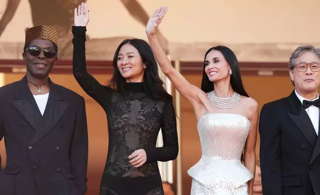 Jury president Park Chan-wook, fourth from left, poses with jury members Isaach de Bankolé, from left, Chloé Zhao and Demi Moore at the opening ceremony and premiere of the film 'The Electric Kiss' during 79th international film festival, Cannes, southern France, Tuesday, May 12, 2026. (Photo by Scott A Garfitt/Invision/AP)